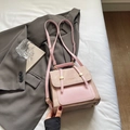 Pink and brown vintage leather backpack with large capacity for women on a stylish bed - Pink Without Pendant