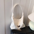 White hobo shoulder bag with embossed texture and dark metal butterfly buckle - White