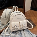 Minimalist beige glossy backpack with front buckle pockets and silver metal zippers - White