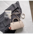 Minimalist beige lychee grain leather boston handbag with silver metal hardware and straps - No Pendant / Off White