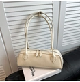 Macro shot of cream crinkled leather shoulder bag with dual zipper and thin straps - White