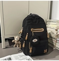 Détails d'un sac à dos noir en nylon avec un porte-clé singe et une petite pochette ronde - Avec Pendentif / Noir