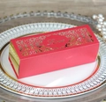 Close-up of laser-cut red and gold favor box with Love text on decorative porcelain plate - Pearlescent Red