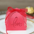 Detail of red laser-cut lace wedding favor box with Love script and ribbon bow - Pearlescent Red
