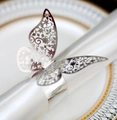 Macro shot of silver butterfly napkin ring with laser-cut floral hollow texture - Reflective Silver