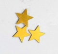 Detail of laser-cut gold hollow star decorations with matte finish texture - Gold
