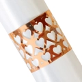Detailed macro view of rose gold napkin ring with laser-cut heart patterns on white satin - Reflective Rose Gold
