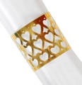 Macro shot of gold metal napkin ring with hollow heart cutouts on a white satin napkin - Reflective Gold