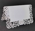 Elegant white laser-cut wedding place cards with scroll patterns for formal table settings - White