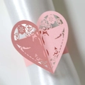 Close-up of pink laser-cut heart napkin ring with bird and floral patterns - Pink