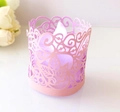 Close-up of pink laser-cut floral paper lamp cover with an LED tea light candle inside - Pink