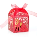 Macro shot of laser-cut wedding candy box with red glitter and groom-bride pattern - Glitter Red