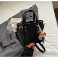 Black litchi grain bucket bag with a cute plush dog pendant and detachable strap - Black