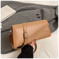 Detailed macro view of tan rectangular leather bag with silver buckle and geometric stitching - Khaki