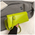 Close-up of lime green rectangular crossbody bag with asymmetrical stitching and silver buckle - Green