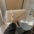 Modern white geometric crossbody bag with unique asymmetrical shape and silver buckle - White