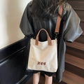 Sac fourre-tout en toile rétro beige avec anses marron et broderie dans un cadre minimaliste - Gris clair