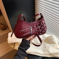 Burgundy pleated crescent bag with silver buckles and zippers for a moto-chic style - Red