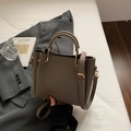 Taupe pebbled leather bucket bag with gold hardware and detachable shoulder strap - Gray