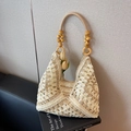 Chic beige woven straw tote bag with vibrant yellow wooden bead handles and floral accent - Khaki And Beige