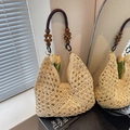 Chic beige crochet woven tote bag featuring dark brown beaded handles and hollow design - Off White