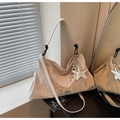 Detail of beige nylon tote bag featuring a star charm and Swagger branding label - Beige With Charm