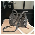 Detail of distressed denim hobo bag with silver eyelets and adjustable wide shoulder strap - Denim Black