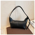Close-up of black leather dumpling bag featuring a decorative knot on the shoulder strap - One Size / Black