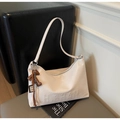Detail of cream hobo bag with H.SHAN embossing and a brown bear pendant charm - White