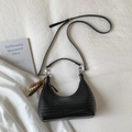 Top view of black woven moon bag with ethnic wooden bead tassels on white fabric - Black