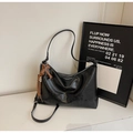 Detail of black dumpling bag with H.SHAN embossed logo and brown leather tassel - Black