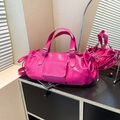 Bright pink Boston handbag with lychee texture and drawstring detail on a desk - Rose Red