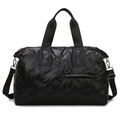 Black quilted travel bag with large capacity featuring shoulder straps and a glossy finish - Black