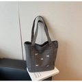Detail view of grey canvas tote bag featuring embroidered puppies and woven brand tag - Dark Brown