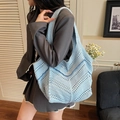 Light blue hand-knitted tote bag with hollow geometric patterns and wide shoulder strap - Blue