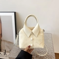 Creamy white shirt-shaped handbag with leather texture and button details - Off White