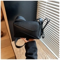 Detailed view of black litchi grain leather shoulder bag with geometric puzzle stitching - Black