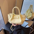 Pale yellow leather bucket bag with bow detail and double round handles for women - Yellow