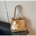Detail of khaki bucket bag with matte leather texture and cute plush puppy charm - With Pendant / Khaki