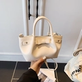 Chic cream white pebble leather bucket bag with a bow detail and adjustable shoulder strap - Off White