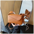 Close-up of brown litchi pattern leather shoulder bag with wavy flap design - Brown