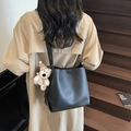 Minimalist black leather bucket bag with cute bear charm and wide shoulder strap - With Charm / Black