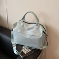 Light blue water-resistant travel tote bag with reinforced handles and adjustable strap - Blue