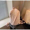 Detail of light pink canvas backpack featuring unique diagonal zippers and crinkled texture - Pink