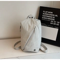 Detail of light gray textured crossbody bag featuring diagonal zipper and round logo - Grey/White