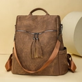 Vintage dark brown PU leather backpack featuring stylish dual leather tassel charms - Brown