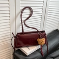 Dark red glossy faux leather shoulder bag with bear charm and tassel detail - Burgundy