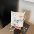 White crossbody phone bag with intricate blue butterfly and pink floral embroidery - Off White