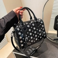Fashionable black glossy Boston bag with silver studs and adjustable shoulder strap - Black