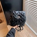 Small black quilted backpack with silver twist lock and chain strap details - Black